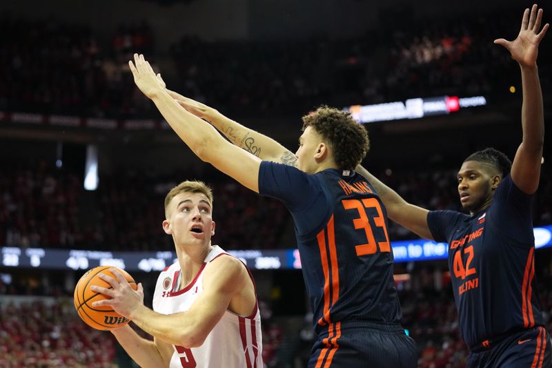 Jan 28, 2023; Madison, Wisconsin, USA;  Wisconsin Badgers forward Tyler Wahl (5) looks to the basket against Illinois Fighting Illini forward Coleman Hawkins (33) and Illinois Fighting Illini forward Dain Dainja (42) during the second half at the Kohl Center. Mandatory Credit: Kayla Wolf-USA TODAY Sports