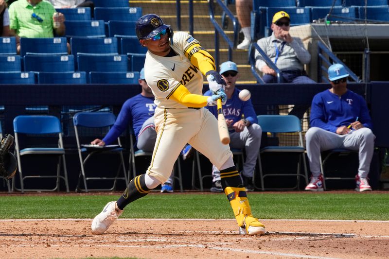 Mar 16, 2024; Phoenix, Arizona, USA; Milwaukee Brewers catcher William Contreras (24) hits against the Texas Rangers in the third inning at American Family Fields of Phoenix. Mandatory Credit: Rick Scuteri-USA TODAY Sports