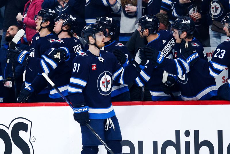 Apr 16, 2024; Winnipeg, Manitoba, CAN;  Winnipeg Jets forward Kyle Connor (81) is congratulated by his teammates after a goal against the Seattle Kraken during the first period at Canada Life Centre. Mandatory Credit: Terrence Lee-USA TODAY Sports