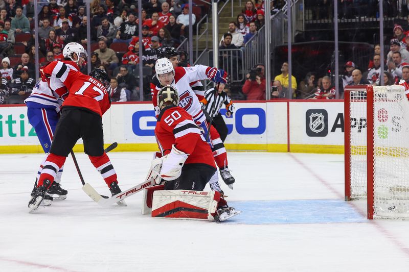 Jan 17, 2024; Newark, New Jersey, USA; Montreal Canadiens right wing Cole Caufield (22) scores a goal on New Jersey Devils goaltender Nico Daws (50) during the third period at Prudential Center. Mandatory Credit: Ed Mulholland-USA TODAY Sports