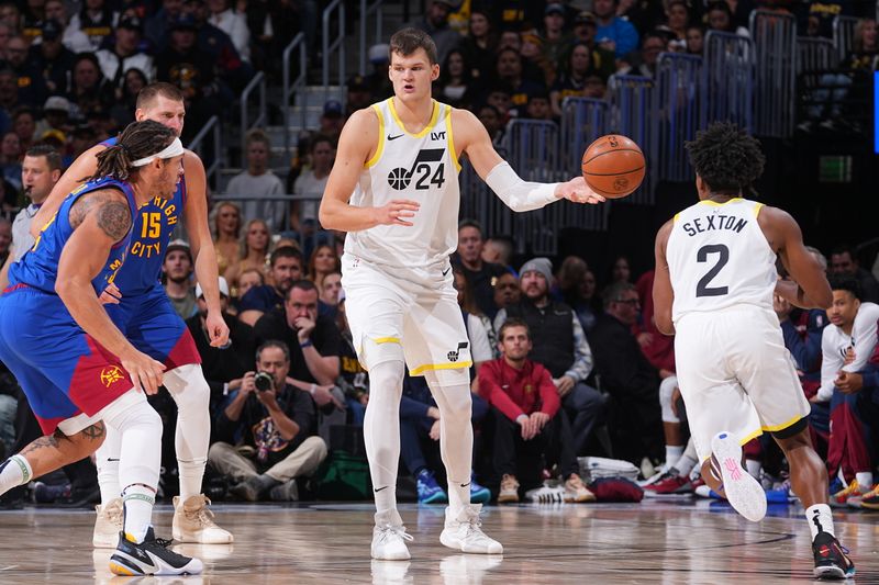 DENVER, CO - NOVEMBER 2:  Walker Kessler #24 of the Utah Jazz. passes the ball during the game against the Denver Nuggets during a regular season game on November 22, 2024 at Ball Arena in Denver, Colorado. NOTE TO USER: User expressly acknowledges and agrees that, by downloading and/or using this Photograph, user is consenting to the terms and conditions of the Getty Images License Agreement. Mandatory Copyright Notice: Copyright 2024 NBAE (Photo by Bart Young/NBAE via Getty Images)