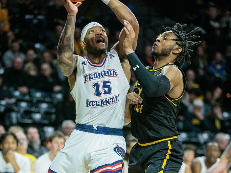 Feb 11, 2024; Wichita, Kansas, USA; Florida Atlantic Owls guard Alijah Martin (15) drives to the basket around Wichita State Shockers guard Colby Rogers (4) during the second half at Charles Koch Arena. Mandatory Credit: William Purnell-USA TODAY Sports