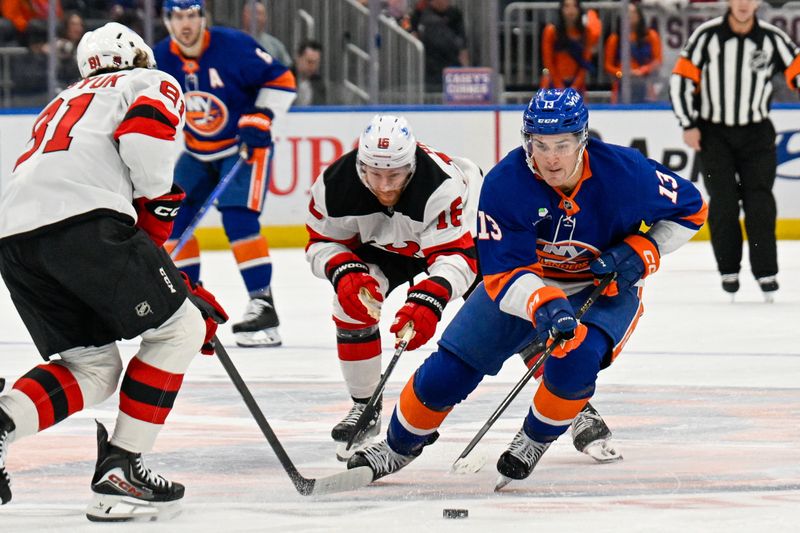 Dec 23, 2025; Elmont, New York, USA;  New York Islanders center Mathew Barzal (13) skates with the puck defended by New Jersey Devils right wing Arseny Gritsyuk (81) during the second period at UBS Arena. Mandatory Credit: Dennis Schneidler-Imagn Images