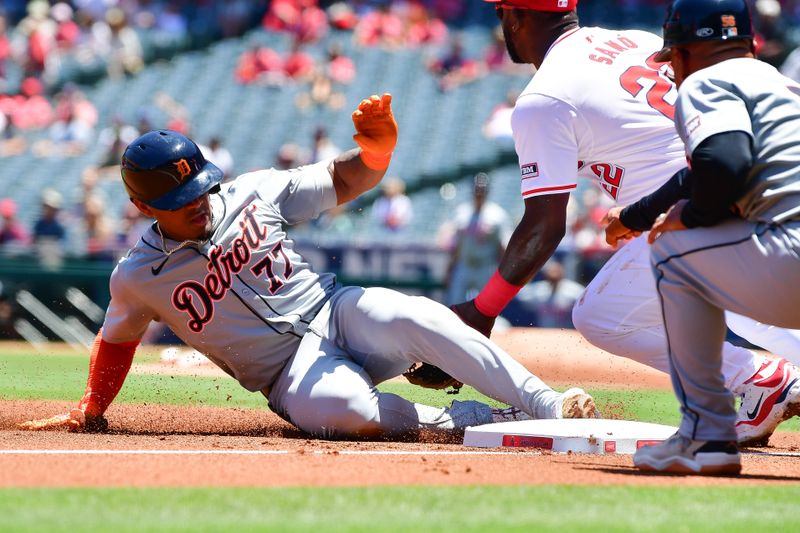 Jun 27, 2024; Anaheim, California, USA; Detroit Tigers second base Andy Ibáñez (77) reaches third on a triple against the Los Angeles Angels during the first inning at Angel Stadium. Mandatory Credit: Gary A. Vasquez-USA TODAY Sports