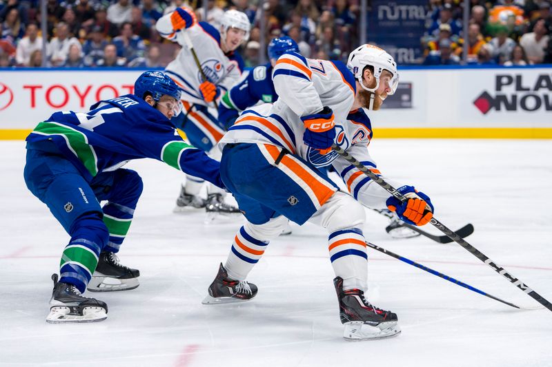 May 16, 2024; Vancouver, British Columbia, CAN; Vancouver Canucks forward Pius Suter (24) stick checks Edmonton Oilers forward Connor McDavid (97) during the second period in game five of the second round of the 2024 Stanley Cup Playoffs at Rogers Arena. Mandatory Credit: Bob Frid-USA TODAY Sports