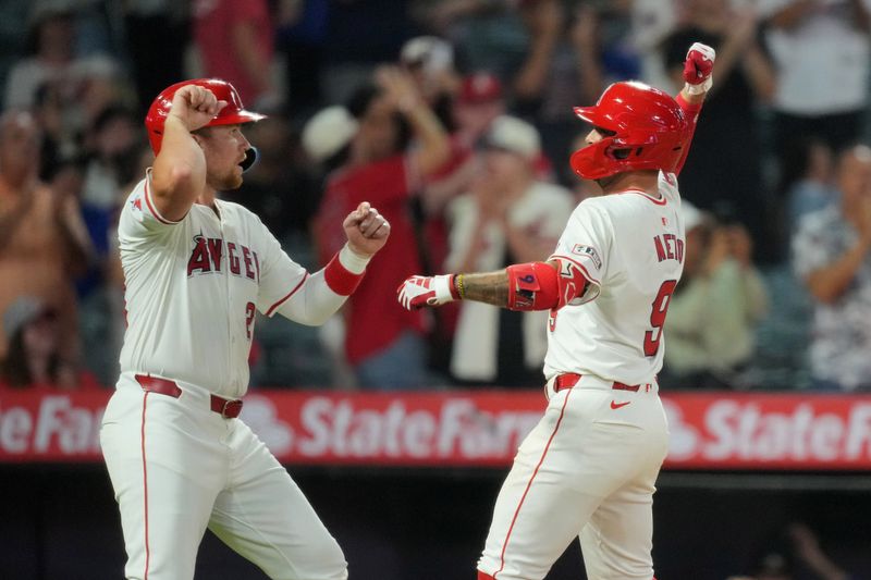 Jul 10, 2024; Anaheim, California, USA; Los Angeles Angels shortstop Zach Neto (9) celebrates with catcher Matt Thaiss (21) after hitting a two-run home run in the eighth inning against the Texas Rangers at Angel Stadium. Mandatory Credit: Kirby Lee-USA TODAY Sports