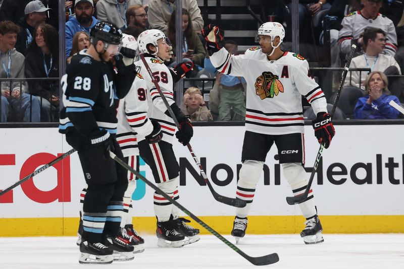 Feb 25, 2025; Salt Lake City, Utah, USA; The Chicago Blackhawks celebrate a goal by defenseman Seth Jones (right) against the Utah Hockey Club during the first period at Delta Center. Mandatory Credit: Rob Gray-Imagn Images