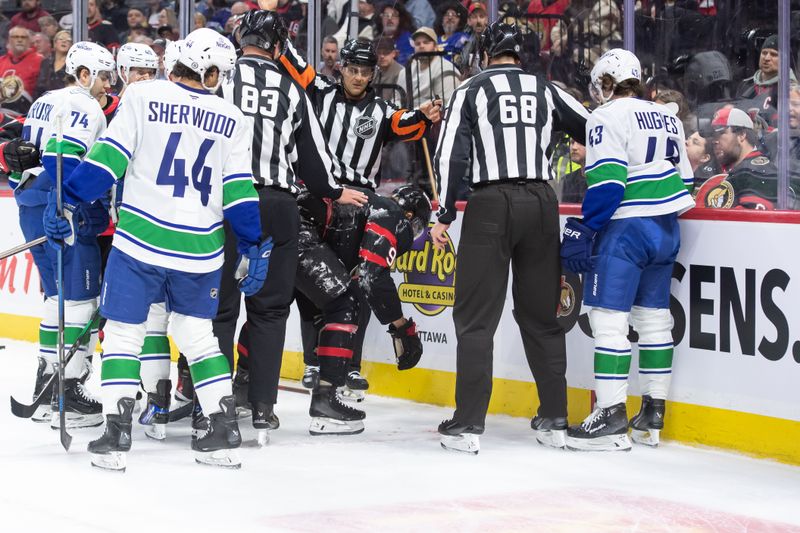 Nov 23, 2024; Ottawa, Ontario, CAN; Vancouver Canucks defenseman Quinn Hughes (43) is given a game misconduct for boarding Ottawa Senators center Josh Norris (9) in the first period at the Canadian Tire Centre. Mandatory Credit: Marc DesRosiers-Imagn Images