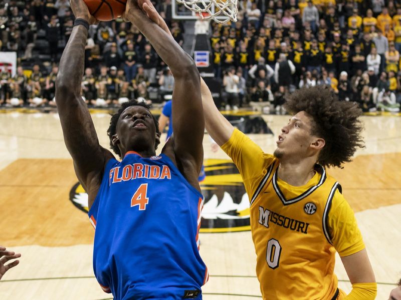 Jan 20, 2024; Columbia, Missouri, USA; Florida Gators forward Tyrese Samuel (4) goes up for a dunk against Missouri Tigers forward Jordan Butler (0) during the first half at Mizzou Arena. Mandatory Credit: Jay Biggerstaff-USA TODAY Sports