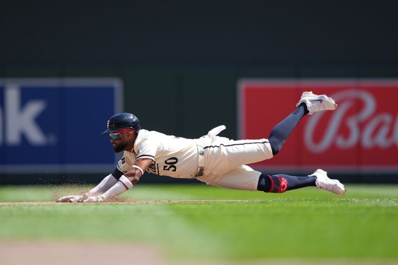 Aug 11, 2024; Minneapolis, Minnesota, USA; Minnesota Twins shortstop Willi Castro (50) slides into second base after hitting a double during the fifth inning against the Cleveland Guardians at Target Field. Mandatory Credit: Jordan Johnson-USA TODAY Sports