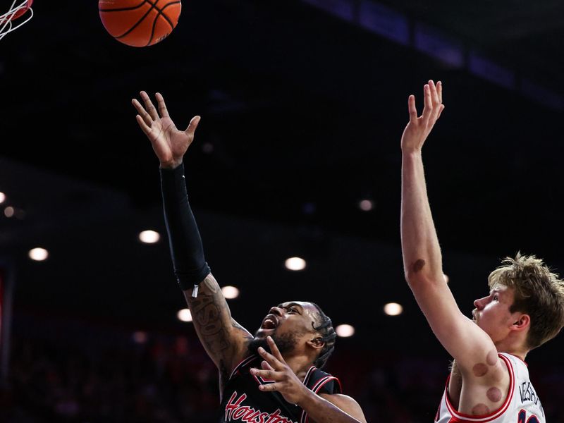 Feb 15, 2025; Tucson, Arizona, USA; Houston Cougars forward J’Wan Roberts (13) makes a lay up while Arizona Wildcats forward Henri Veesaar (13) fails to block him during the first half at McKale Center. Mandatory Credit: Aryanna Frank-Imagn Images