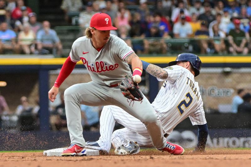 Sep 2, 2023; Milwaukee, Wisconsin, USA; Milwaukee Brewers second baseman Brice Turang (2) steals second base as Philadelphia Phillies second baseman Bryson Stott (5) tries to catch the ball in the second inning at American Family Field. Mandatory Credit: Benny Sieu-USA TODAY Sports