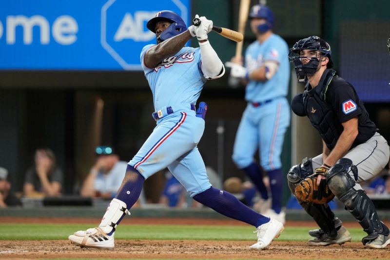 Jul 16, 2023; Arlington, Texas, USA; Texas Rangers right fielder Adolis Garcia (53) follows through on his RBI double against the Cleveland Guardians during the eighth inning at Globe Life Field. Mandatory Credit: Jim Cowsert-USA TODAY Sports