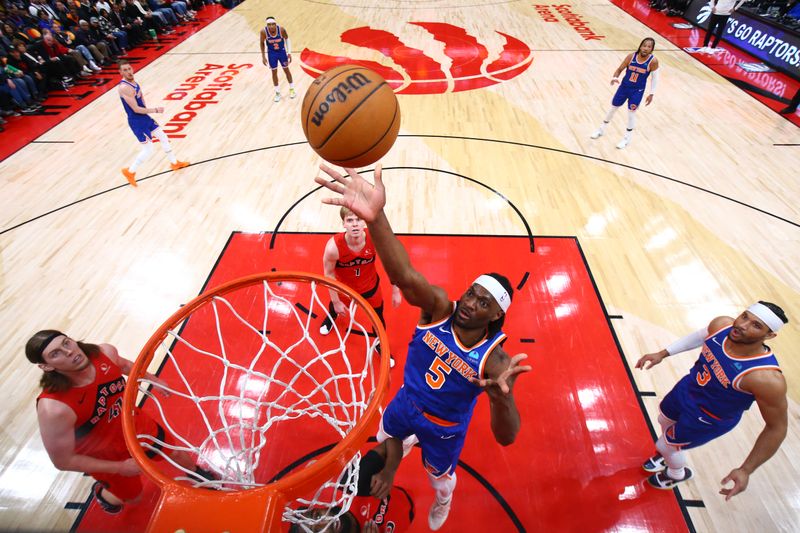 TORONTO, CANADA - MARCH 27: Precious Achiuwa #5 of the New York Knicks drives to the basket during the game against the Toronto Raptors on March 27, 2024 at the Scotiabank Arena in Toronto, Ontario, Canada.  NOTE TO USER: User expressly acknowledges and agrees that, by downloading and or using this Photograph, user is consenting to the terms and conditions of the Getty Images License Agreement.  Mandatory Copyright Notice: Copyright 2024 NBAE (Photo by Vaughn Ridley/NBAE via Getty Images)