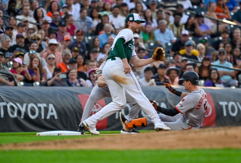 Jul 20, 2024; Denver, Colorado, USA; San Francisco Giants outfielder Mike Yastrzemski (5) slides in at third base for a triple against Colorado Rockies third base Ryan McMahon (24) in the fifth inning at Coors Field. Mandatory Credit: John Leyba-USA TODAY Sports