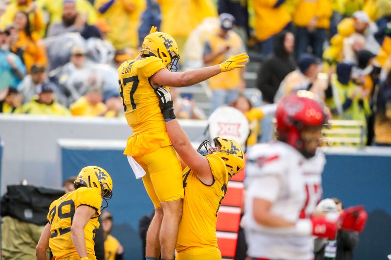 Sep 23, 2023; Morgantown, West Virginia, USA; West Virginia Mountaineers tight end Kole Taylor (87) celebrates with teammates after catching a pass for a touchdown against the Texas Tech Red Raiders during the fourth quarter at Mountaineer Field at Milan Puskar Stadium. Mandatory Credit: Ben Queen-USA TODAY Sports