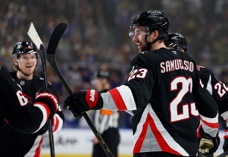 Dec 27, 2025; Buffalo, New York, USA;  Buffalo Sabres defenseman Mattias Samuelsson (23) celebrates his goal with teammates during the second period against the Boston Bruins at KeyBank Center. Mandatory Credit: Timothy T. Ludwig-Imagn Images