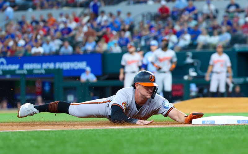Jul 21, 2024; Arlington, Texas, USA;  Baltimore Orioles left fielder Austin Hays (21) slides into third base during the second inning against the Texas Rangers at Globe Life Field. Mandatory Credit: Kevin Jairaj-USA TODAY Sports