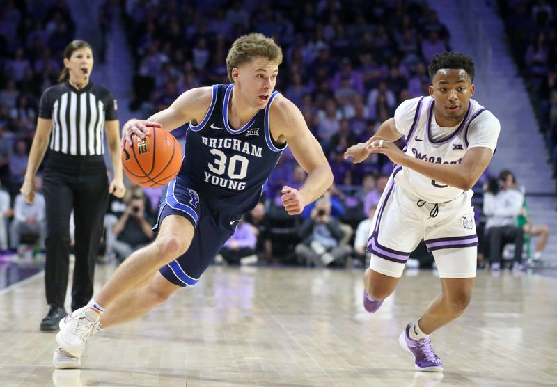 Feb 24, 2024; Manhattan, Kansas, USA; Brigham Young Cougars guard Dallin Hall (30) dribbles against Kansas State Wildcats guard Tylor Perry (2) during the second half at Bramlage Coliseum. Mandatory Credit: Scott Sewell-USA TODAY Sports