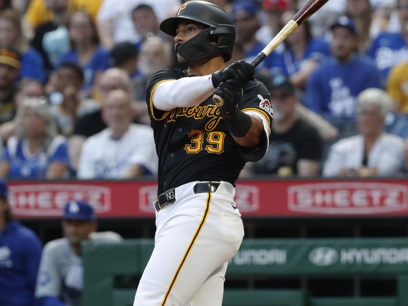 Jun 6, 2024; Pittsburgh, Pennsylvania, USA;  Pittsburgh Pirates second baseman Nick Gonzales (39) hits a two-run home run against the Los Angeles Dodgers during the third inning at PNC Park. Mandatory Credit: Charles LeClaire-USA TODAY Sports