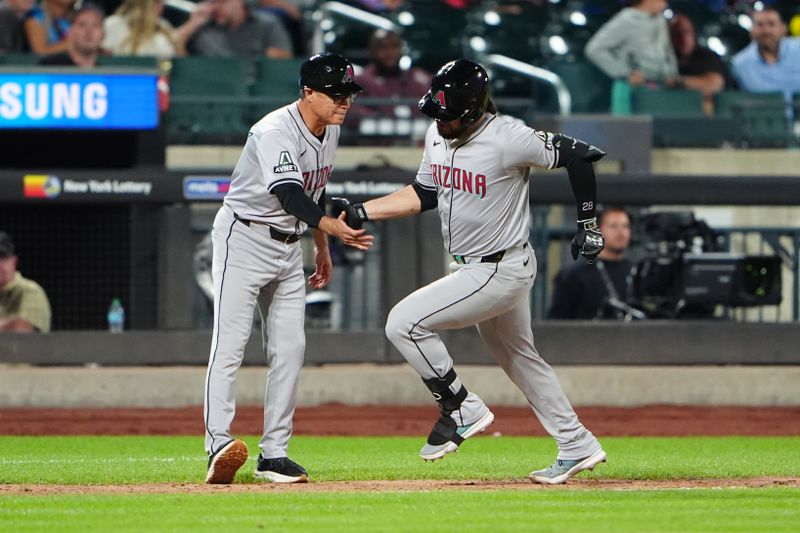 May 31, 2024; New York City, New York, USA; Arizona Diamondbacks third base coach Tony Perezchica (21) congratulates third baseman Eugenio Suarez (28) for hitting a home run against the New York Mets during the sixth inning at Citi Field. Mandatory Credit: Gregory Fisher-USA TODAY Sports