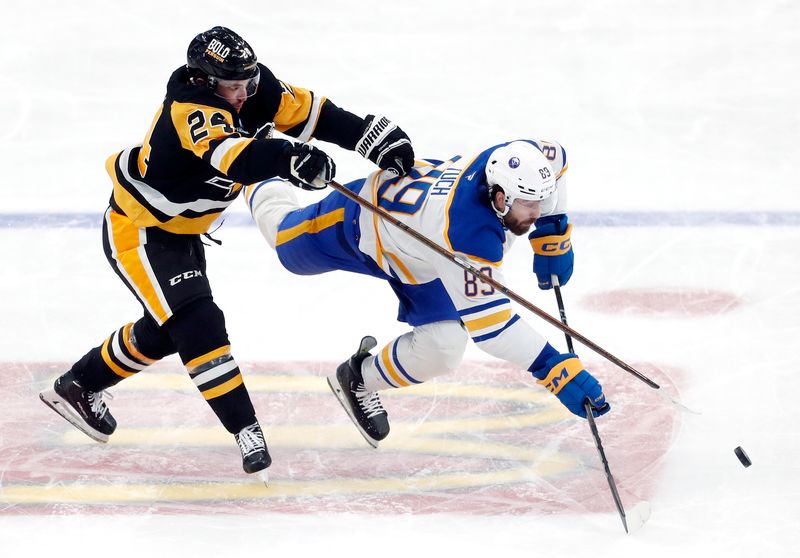 Oct 16, 2024; Pittsburgh, Pennsylvania, USA; Pittsburgh Penguins defenseman Matt Grzelcyk (24) commits a tripping penalty against Buffalo Sabres right wing Alex Tuch (89) during the second period at PPG Paints Arena. Mandatory Credit: Charles LeClaire-Imagn Images