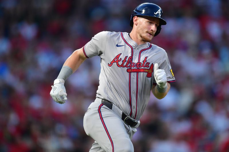 August 16, 2024; Anaheim, California, USA; Atlanta Braves catcher Sean Murphy (12) runs after hitting an RBI single against the Los Angeles Angels during the fourth inning at Angel Stadium. Mandatory Credit: Gary A. Vasquez-USA TODAY Sports