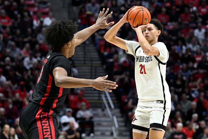 Jan 6, 2024; San Diego, California, USA; San Diego State Aztecs guard Miles Byrd (21) shoots the ball over UNLV Rebels forward Rob Whaley Jr. (5) during the first half at Viejas Arena. Mandatory Credit: Orlando Ramirez-USA TODAY Sports