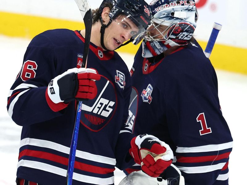 Oct 24, 2025; Winnipeg, Manitoba, CAN; Winnipeg Jets center Morgan Barron (36) and Winnipeg Jets goaltender Eric Comrie (1) celebrate their victory against the Calgary Flames at Canada Life Centre. Mandatory Credit: James Carey Lauder-Imagn Images