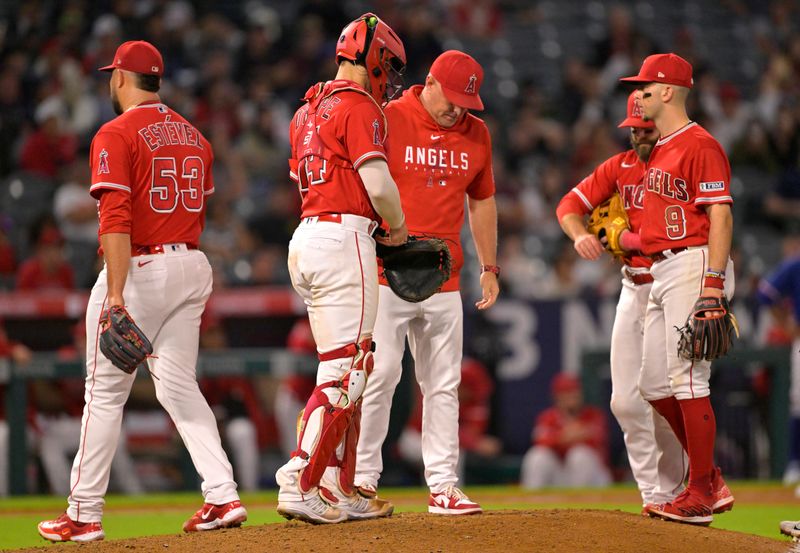 Sep 27, 2023; Anaheim, California, USA;  Los Angeles Angels relief pitcher Carlos Estevez (53) walks to the dugout after he was pulled from the game by manager Phil Nevin (88) after giving up 3 runs in the ninth inning against the Texas Rangers at Angel Stadium. Mandatory Credit: Jayne Kamin-Oncea-USA TODAY Sports