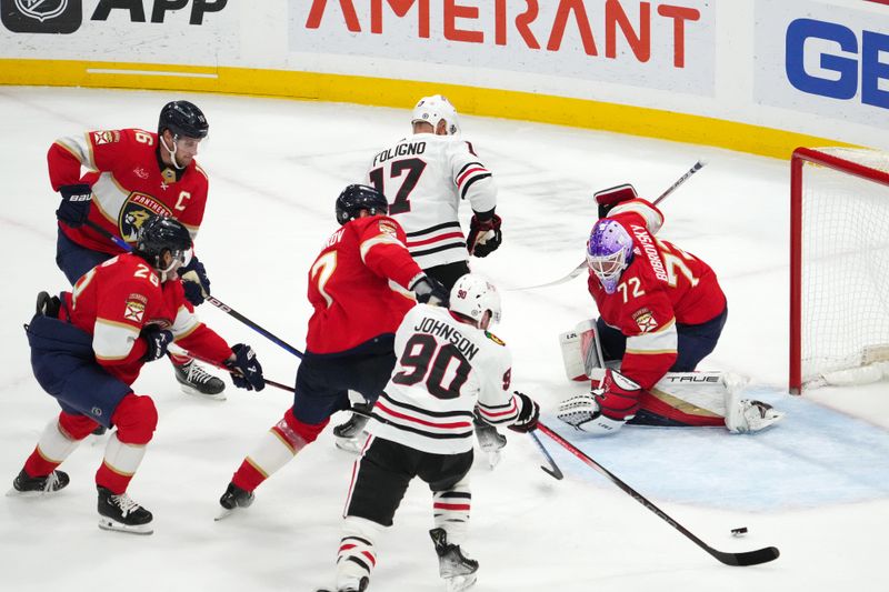 Nov 12, 2023; Sunrise, Florida, USA; Chicago Blackhawks center Tyler Johnson (90) and Florida Panthers defenseman Dmitry Kulikov (7) battle for a loose puck in front of goaltender Sergei Bobrovsky (72) during the third period at Amerant Bank Arena. Mandatory Credit: Jasen Vinlove-USA TODAY Sports