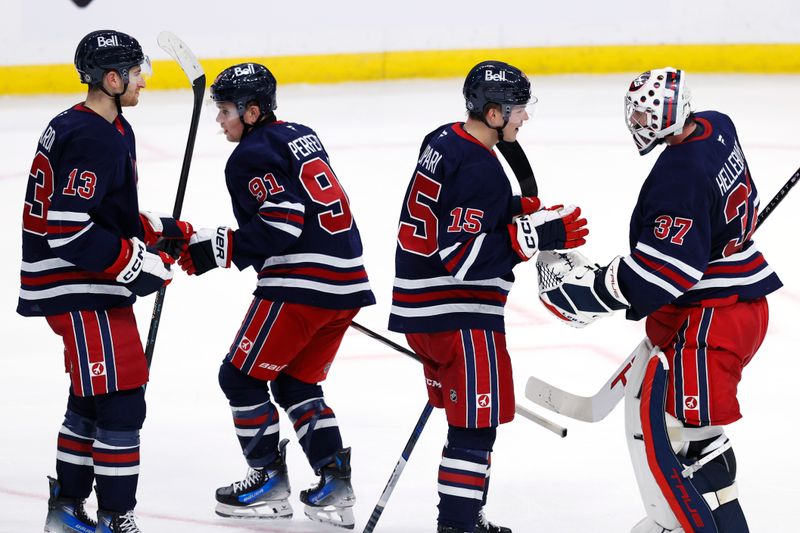 Nov 9, 2024; Winnipeg, Manitoba, CAN; Winnipeg Jets celebrate their victory over the Dallas Stars at Canada Life Centre. Mandatory Credit: James Carey Lauder-Imagn Images