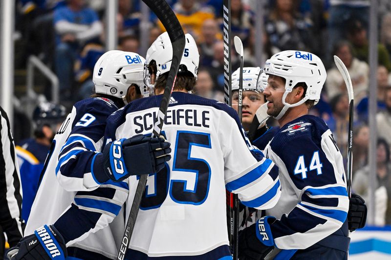 Nov 7, 2023; St. Louis, Missouri, USA;  Winnipeg Jets center Mark Scheifele (55) is congratulated by teammates after scoring against the St. Louis Blues during the first period at Enterprise Center. Mandatory Credit: Jeff Curry-USA TODAY Sports