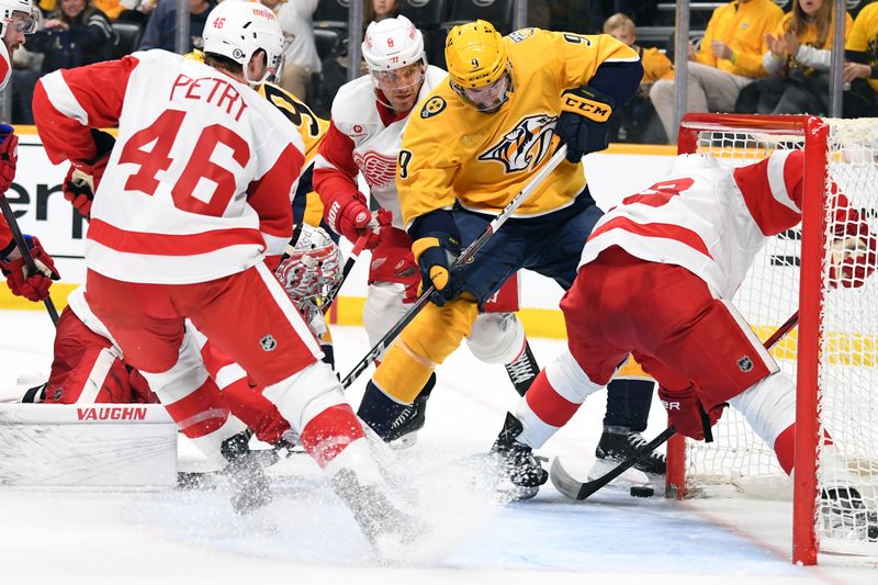 Mar 23, 2024; Nashville, Tennessee, USA; Nashville Predators left wing Filip Forsberg (9) plays the puck at the side of the net after a save by Detroit Red Wings goaltender Alex Lyon (34) during the third period at Bridgestone Arena. Mandatory Credit: Christopher Hanewinckel-USA TODAY Sports