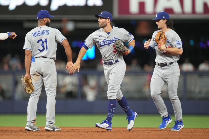 Sep 7, 2023; Miami, Florida, USA; Los Angeles Dodgers left fielder Chris Taylor (3) celebrates a victory over the Miami Marlins with shortstop Amed Rosario (31) at loanDepot Park. Mandatory Credit: Jim Rassol-USA TODAY Sports
