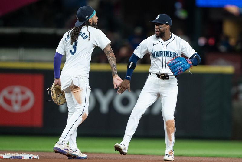 Sep 11, 2024; Seattle, Washington, USA;  Seattle Mariners left fielder Randy Arozarena (56) and shortstop J.P. Crawford (3) celebrate after a game against the San Diego Padres at T-Mobile Park. Mandatory Credit: Stephen Brashear-Imagn Images