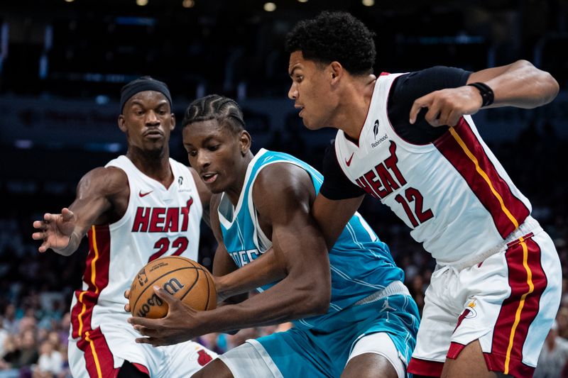 CHARLOTTE, NORTH CAROLINA - OCTOBER 26: Dru Smith #12 of the Miami Heat tries to knock the ball away from Moussa Diabate #14 of the Charlotte Hornets in the first quarter during their game at Spectrum Center on October 26, 2024 in Charlotte, North Carolina. NOTE TO USER: User expressly acknowledges and agrees that, by downloading and or using this photograph, User is consenting to the terms and conditions of the Getty Images License Agreement. (Photo by Jacob Kupferman/Getty Images)