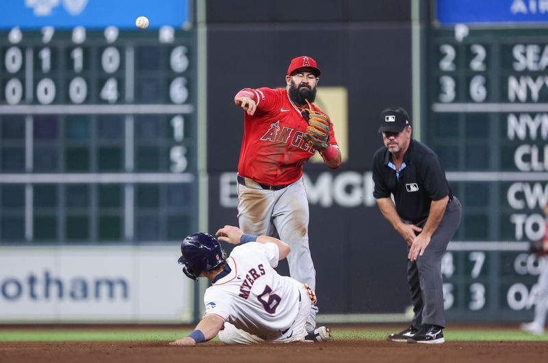 May 21, 2024; Houston, Texas, USA; Houston Astros center fielder Jake Meyers (6) is out at second baseman as Los Angeles Angels second baseman Luis Guillorme (15) throws to first base during the sixth inning at Minute Maid Park. Mandatory Credit: Troy Taormina-USA TODAY Sports