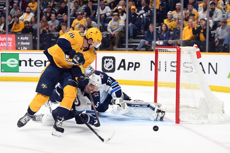 Apr 9, 2024; Nashville, Tennessee, USA; Nashville Predators left wing Cole Smith (36) has a shot blocked by Winnipeg Jets defenseman Brenden Dillon (5) during the third period at Bridgestone Arena. Mandatory Credit: Christopher Hanewinckel-USA TODAY Sports