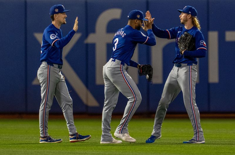 May 6, 2024; Oakland, California, USA; Texas Rangers outfielder Leody Taveras (3), outfielder Evan Carter (32) and outfielder Travis Jankowski (16) celebrate after the game against the Oakland Athletics at Oakland-Alameda County Coliseum. Mandatory Credit: Neville E. Guard-USA TODAY Sports