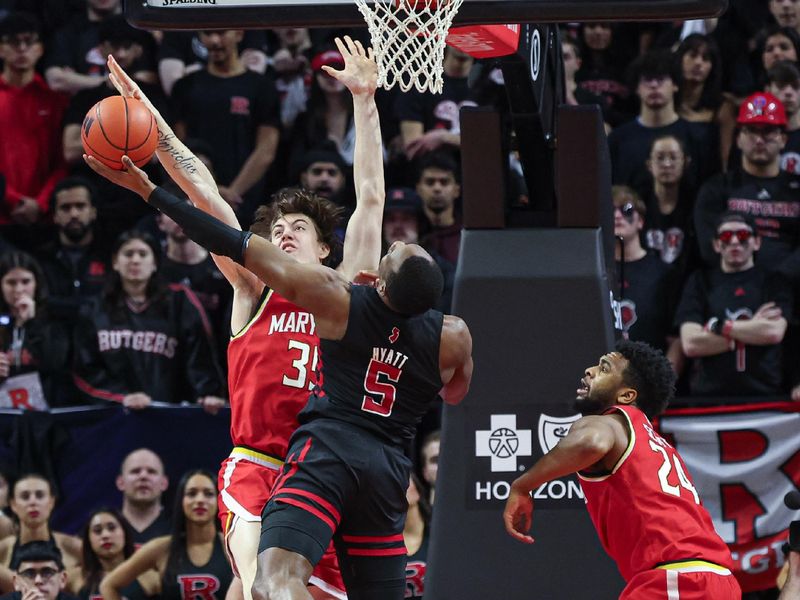 Feb 25, 2024; Piscataway, New Jersey, USA; Rutgers Scarlet Knights forward Aundre Hyatt (5) drives for a shot as Maryland Terrapins center Caelum Swanton-Rodger (35) and forward Donta Scott (24) defend during the first half at Jersey Mike's Arena. Mandatory Credit: Vincent Carchietta-USA TODAY Sports