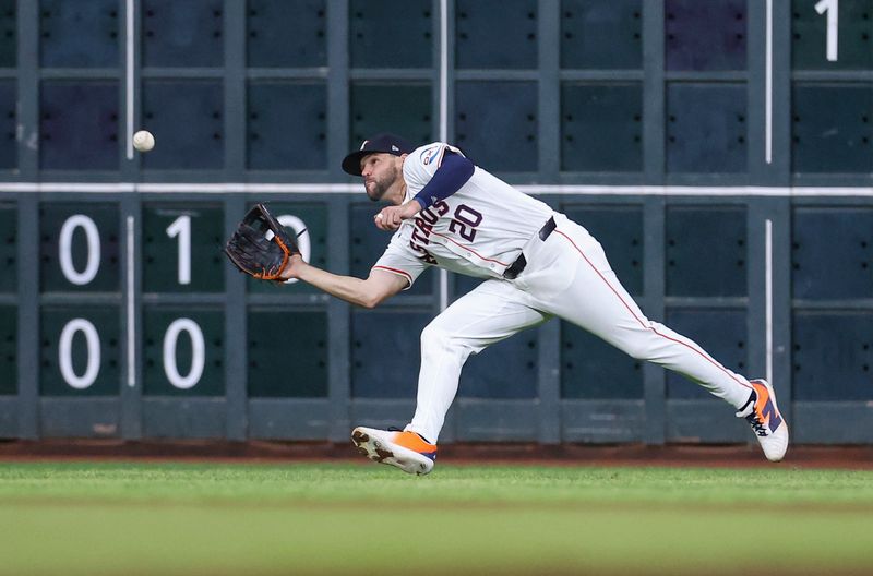 May 21, 2024; Houston, Texas, USA; Houston Astros left fielder Chas McCormick (20) makes a running catch during the fifth inning against the Los Angeles Angels at Minute Maid Park. Mandatory Credit: Troy Taormina-USA TODAY Sports