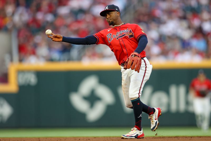 Apr 26, 2024; Atlanta, Georgia, USA; Atlanta Braves second baseman Ozzie Albies (1) throws a runner out at first against the Cleveland Guardians in the first inning at Truist Park. Mandatory Credit: Brett Davis-USA TODAY Sports
