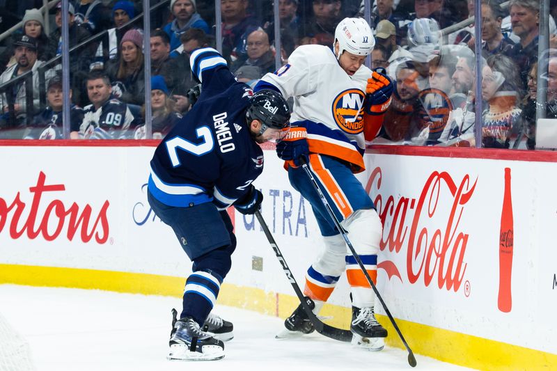 Jan 16, 2024; Winnipeg, Manitoba, CAN; Winnipeg Jets defenseman Dylan DeMelo (2) battles New York Islanders forward Matt Martin (17) along the boards during the first period at Canada Life Centre. Mandatory Credit: Terrence Lee-USA TODAY Sports