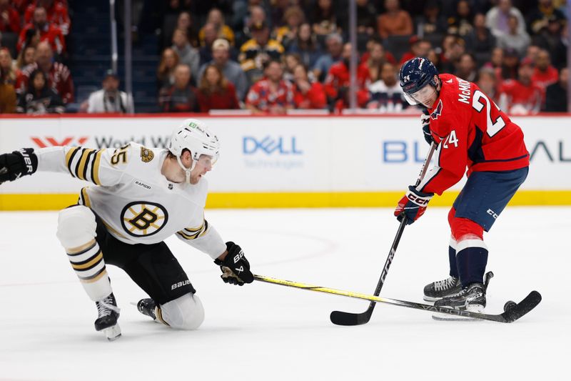 Apr 15, 2024; Washington, District of Columbia, USA; Washington Capitals center Connor McMichael (24) and Boston Bruins defenseman Brandon Carlo (25) battle for the puck in the first period at Capital One Arena. Mandatory Credit: Geoff Burke-USA TODAY Sports