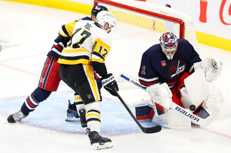 Oct 20, 2024; Winnipeg, Manitoba, CAN; Winnipeg Jets goaltender Connor Hellebuyck (37) makes a save on a shot by Pittsburgh Penguins right wing Bryan Rust (17) in the third period at Canada Life Centre. Mandatory Credit: James Carey Lauder-Imagn Images