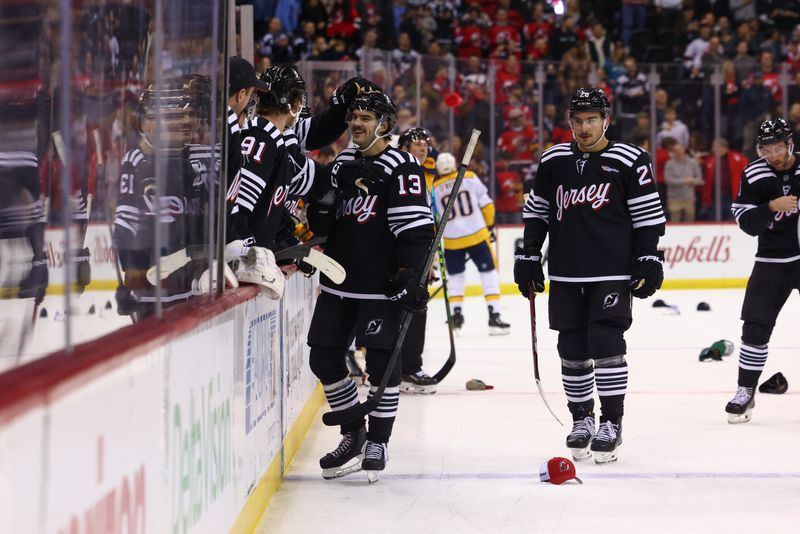 Nov 25, 2024; Newark, New Jersey, USA; New Jersey Devils center Nico Hischier (13) celebrates his goal against the Nashville Predators during the second period at Prudential Center. Mandatory Credit: Ed Mulholland-Imagn Images