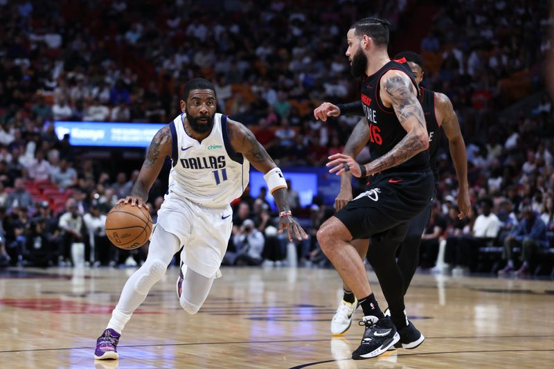 MIAMI, FLORIDA - APRIL 10: Kyrie Irving #11 of the Dallas Mavericks drives against Caleb Martin #16 of the Miami Heat during the first quarter of the game at Kaseya Center on April 10, 2024 in Miami, Florida. NOTE TO USER: User expressly acknowledges and agrees that, by downloading and or using this photograph, User is consenting to the terms and conditions of the Getty Images License Agreement. (Photo by Megan Briggs/Getty Images)