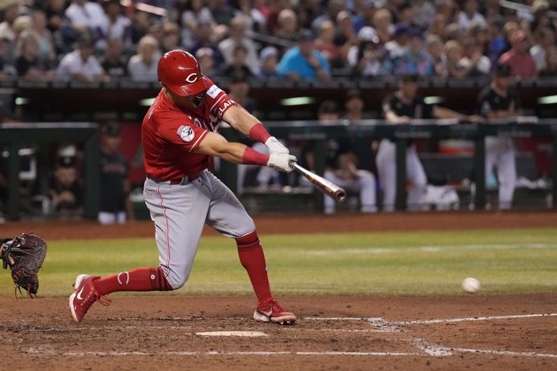 Aug 26, 2023; Phoenix, Arizona, USA; Cincinnati Reds second baseman Matt McLain (9) hits an RBI groundout against the Arizona Diamondbacks during the ninth inning at Chase Field. Mandatory Credit: Joe Camporeale-USA TODAY Sports