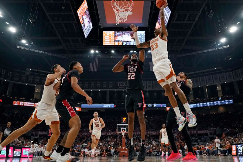 Jan 6, 2024; Austin, Texas, USA; Texas Longhorns forward Dillon Mitchell (23) shoots over Texas Tech Red Raiders forward Warren Washington (22) during the second half at Moody Center. Mandatory Credit: Scott Wachter-USA TODAY Sports